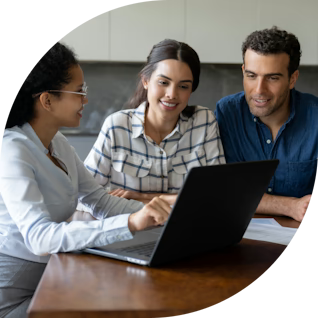 A financial advisor meeting with a client, discussing loan options on a laptop